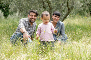 Couple with toddler girl in garden, Florence, Italy Couple with toddler girl in garden, Florence, Italy